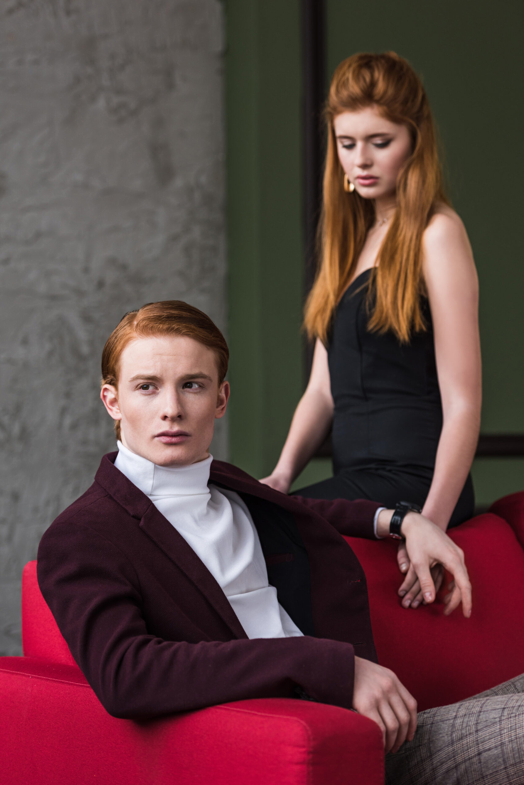 young male fashion model in jacket with girlfriend in black dress